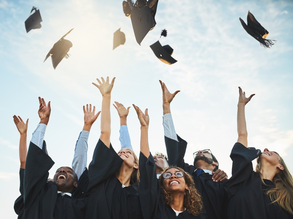 Graduates in caps and gowns celebrating